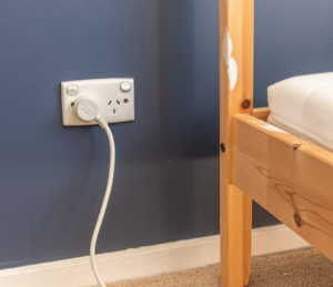 outlet located by bed